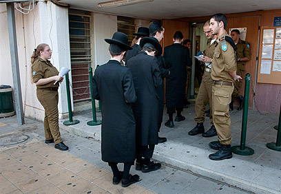 Haredi men at IDF recruitment center issuing enlistment exempt (Photo: Yaron Brenner)