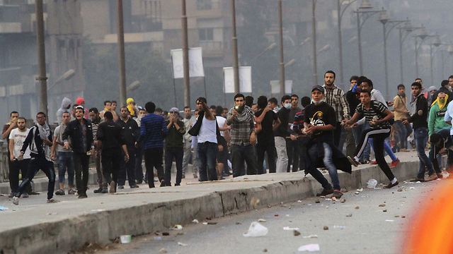 Muslim Brotherhood supporters throwing stones at police during a protest in Cairo, November 2013.  (Photo: AP)