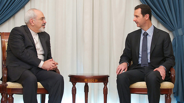 Syria's Assad, right, meets with Iran's Foreign Minister Zarif (Photo: EPA)