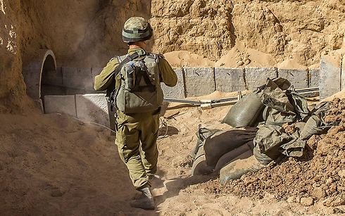IDF soldiers showing the entrance to a Gaza tunnel (Photo: AFP)