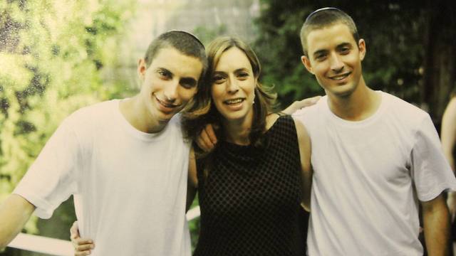 Second Lieutenant Hadar Goldin (left) with his twin brother Tzur (right).
