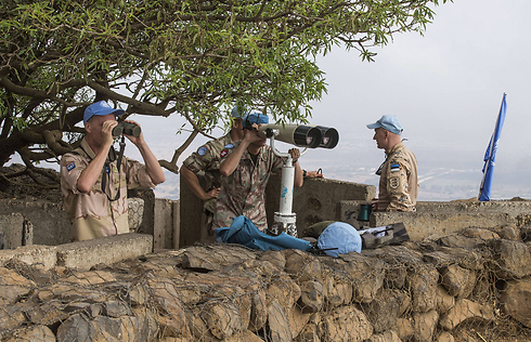 UN Peacekeepers use binoculars to watch the Syrian side of the Golan (Photo: Jack Guez/AFP)