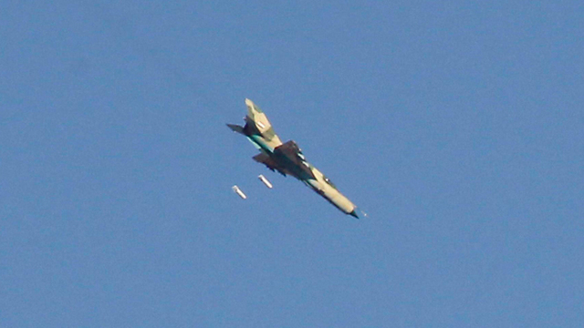 A Syrian fighter jet dropping bombs (Photo: Reuters)