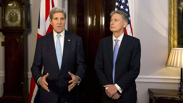 US Secretary of State with UK Foreign Secretary Philip Hammond in November 2014. (Photo: AFP)