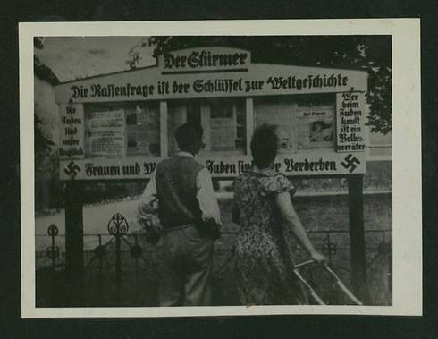 Those buying from Jews are betraying the country, written next to a notice board (Photo courtesy of the National Library) 