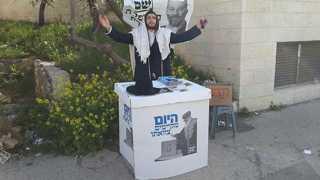 A Shas supporter engages in some last-minute campaigning in Jerusalem 