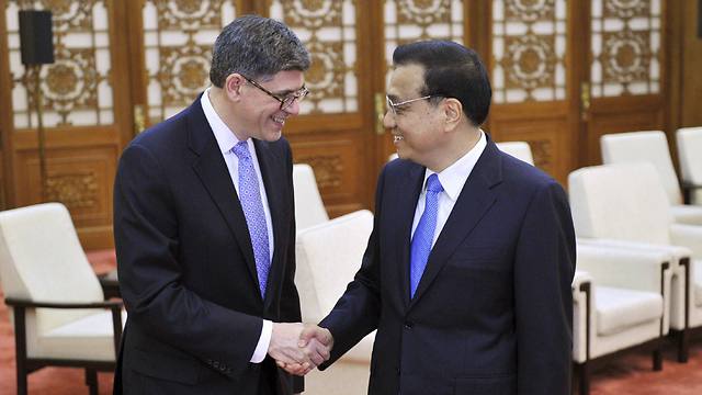 US Treasury Secretary Jack Lew (L) shakes hands with Chinese Premier Li Keqiang before a meeting in Beijing March on 30 (Photo: Reuters)