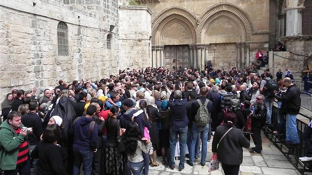 Christian pilgrims outside the Church of the Holy Sepulcher on Holy Saturday (Photo: Ziv Reinstein)