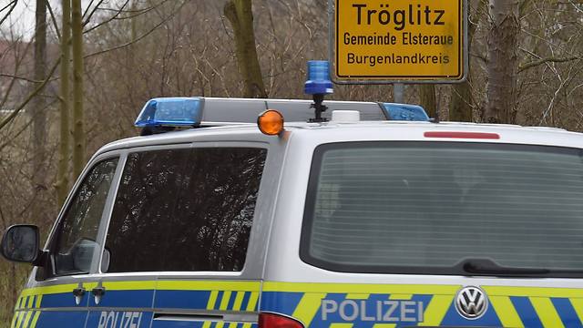 A police car enters the municipality Troeglitz, Germany (Photo: EPA)