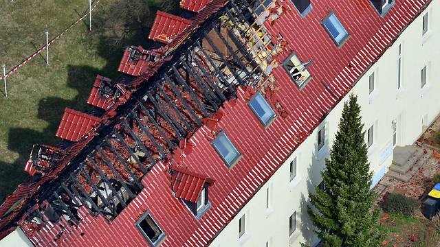 An aerial view of the house with a burned-out roof truss in Troeglitz, Germany (Photo: EPA)