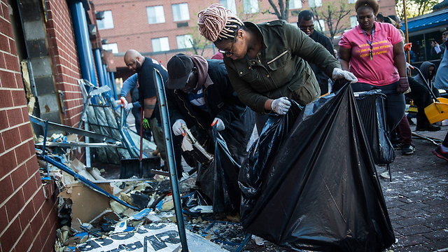 Volunteers cleaning up streets of Baltimore (Photo: AFP)