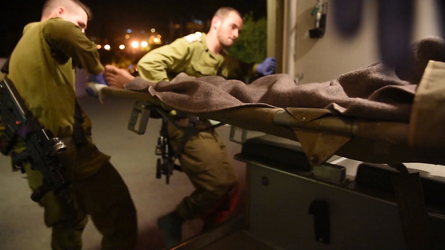 IDF soldiers rush the wounded from Syria to Israel (Photo: Eli Segal)