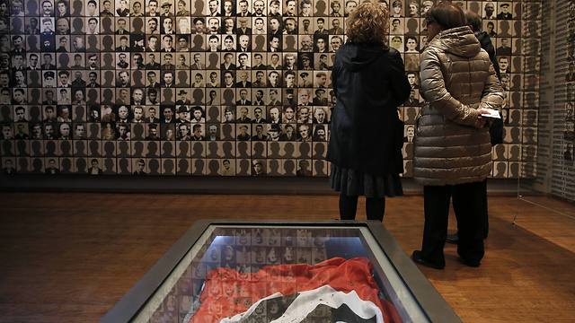 Visitors look at portraits of victims at the Holocaust Museum in the town of Kalavryta, western Greece (Photo: AP)