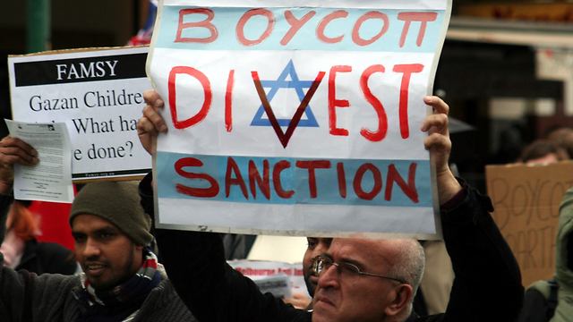 BDS supporter at a protest (Photo: Reuters)