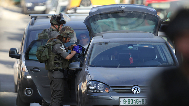 Soldiers search cars near the scene (Photo:AFP)