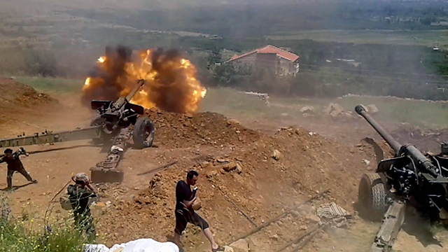 Syrian artillery shelling the besieged town of Zabadani (Photo: EPA)