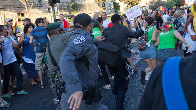 Yishai Shlissel attacks at the parade (Photo: AP)