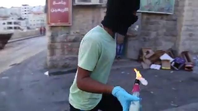 Palestinian throwing Molotov cocktail in East Jerusalem
