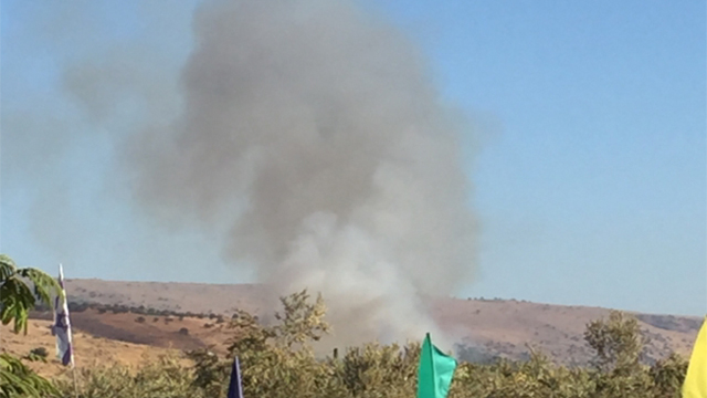 Smoke billows from explosion caused by projectile 