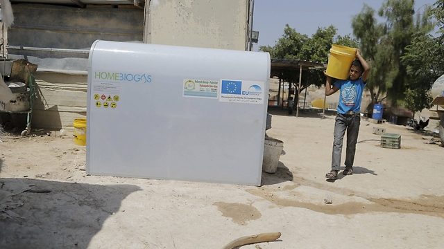 Mohammad Zayed uses a HomeBioGas digester (Photo: Ammar Awad, Reuters)