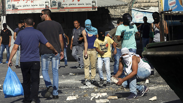 Youths taking part in clashes against security forces (Photo: AP)