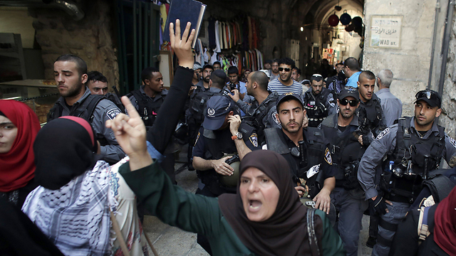 Palestinians and Israeli security forces this month (Photo: AFP)