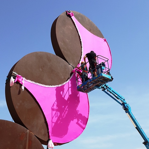 Putting a giant bra on one of Tel Aviv's most famous statues. (Photo: Amit Cotler)