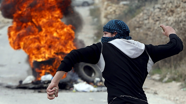 A Palestinian takes part in violent riots (Photo: Reuters)