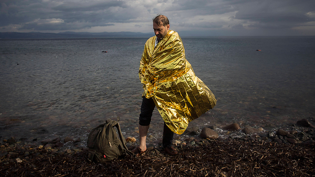 A refugee on the shore of the Greek island of Lesbos. (Photo: AP)