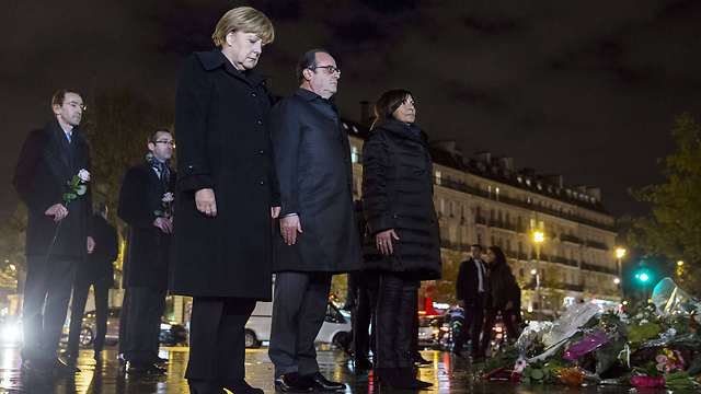 French President Francois Hollande and German Chancellor Angela Merkel honor terror victims in Paris. Europe must wake up and acknowledge that a religious war is brewing between radical Islam and the civilized, democratic and free Western world which includes Israel (Photo: AFP)  