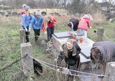 Polish students tending to the Jewish cemetery in Radomsko