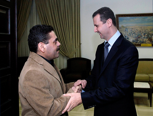 Terrorist Samir Kuntar, who killed Smadar's family, being warmly greeted by Syrian President Bashar Assad (Photo: AP)