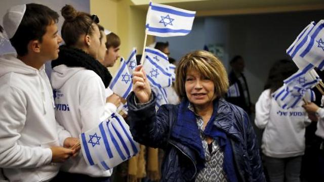 A Jewish immigrant from France arrives for a candle-lighting ceremony to mark Hanukkah, upon landing at Ben Gurion International Airport (Photo: Reuters)