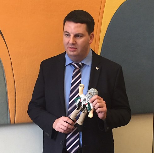 British MP Andrew Percy holding an "incitement doll" 