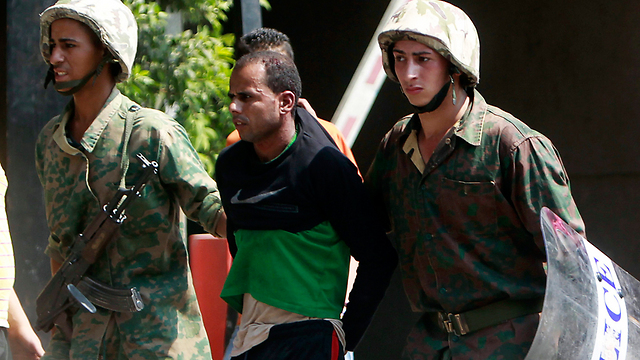 Egyptian troops leading a protester away after demonstrations outside Israeli embassy in Cairo (Photo: Reuters)