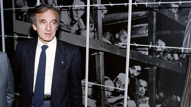 Wiesel next to photo of himself in Buchenwald bunker (Photo: AFP)