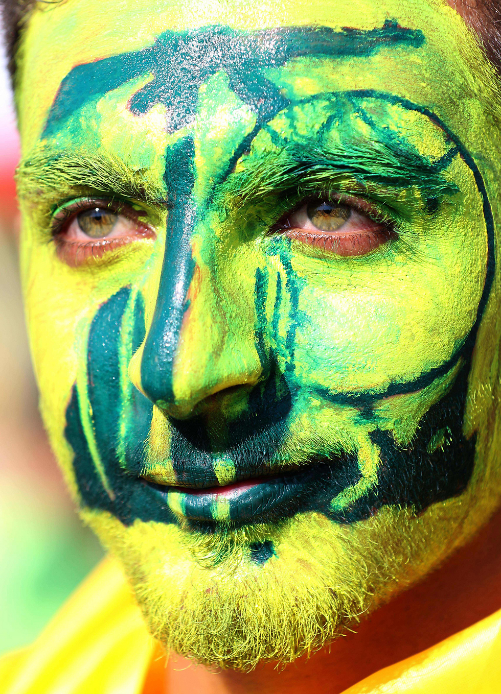 A Hezbollah supporter has his face painted with the Hezbollah logo (Photo: AFP)