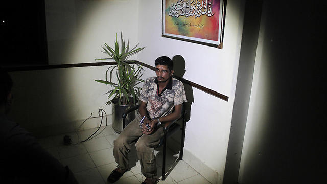 Mubeen Rajhu, who killed his sister Tasneem sits at police headquarters in Lahore (Photo: AP)