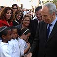 Peres talks to youngsters during his visit