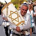 Steve Andrews of Congregation Ahavat Olam carries newly obtained Torah  