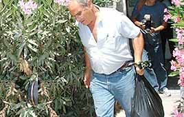 הוטרינר של משרד החקלאות סוחב את גופת הכלב בשקית