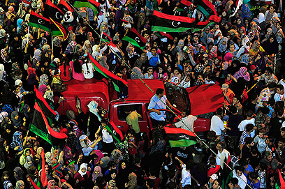 Libyans celebrate Gaddafi's downfall (Photo: Reuters)