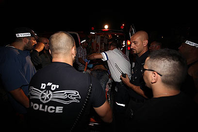 Terrorist lifted onto ambulance (Photo: Moti Kimchi)