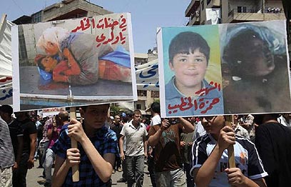 הפגנה ובה מונפות תמונותיו של אל-חטיב (צילום: רויטרס) (צילום: רויטרס)