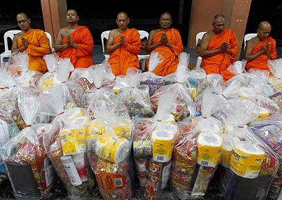 נזירים בודהיסטים מקבלים תרומות מזון (צילום: רויטרס) (צילום: רויטרס)