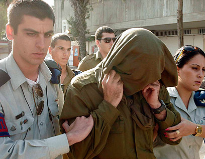 הקצין מסתיר את פניו בדרך לדיון בבית הדין (צילום: אליעד לוי) (צילום: אליעד לוי)