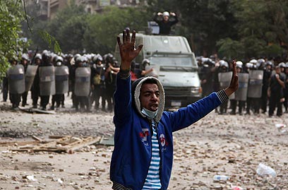 רוצים לשים סוף למשטר הצבאי. כוחות משטרה ומפגין בקהיר (צילום: רויטרס) (צילום: רויטרס)