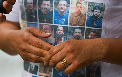 חולצה שעליה תמונות שבויים של המחתרת הקולומביאנית (צילום: AP) (צילום: AP)