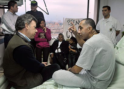 ארסו, גיבור השעה, משוחח בבית החולים עם נשיא קולומביה (צילום: AP) (צילום: AP)