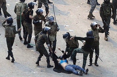 Soldiers dragging woman protester (Photo: Reuters)
